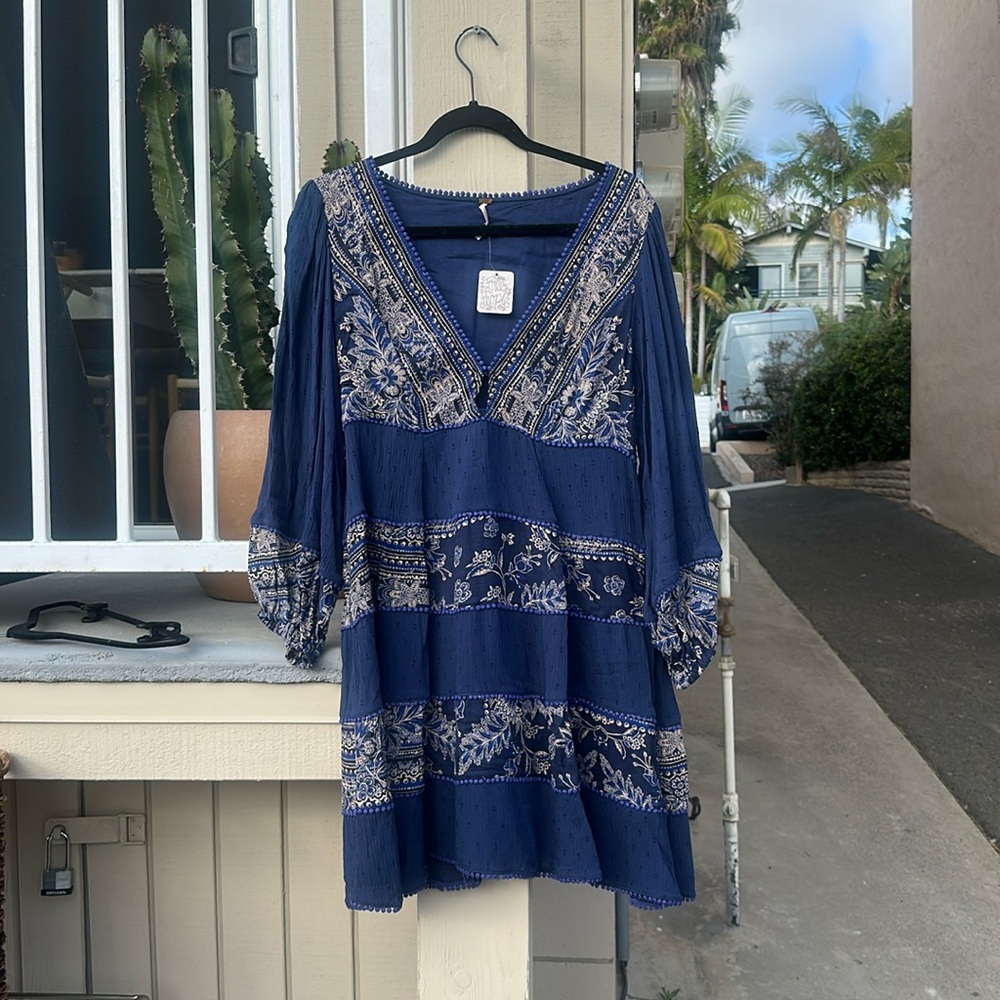 New with tags, never worn blue free people dress with bell sleeves.